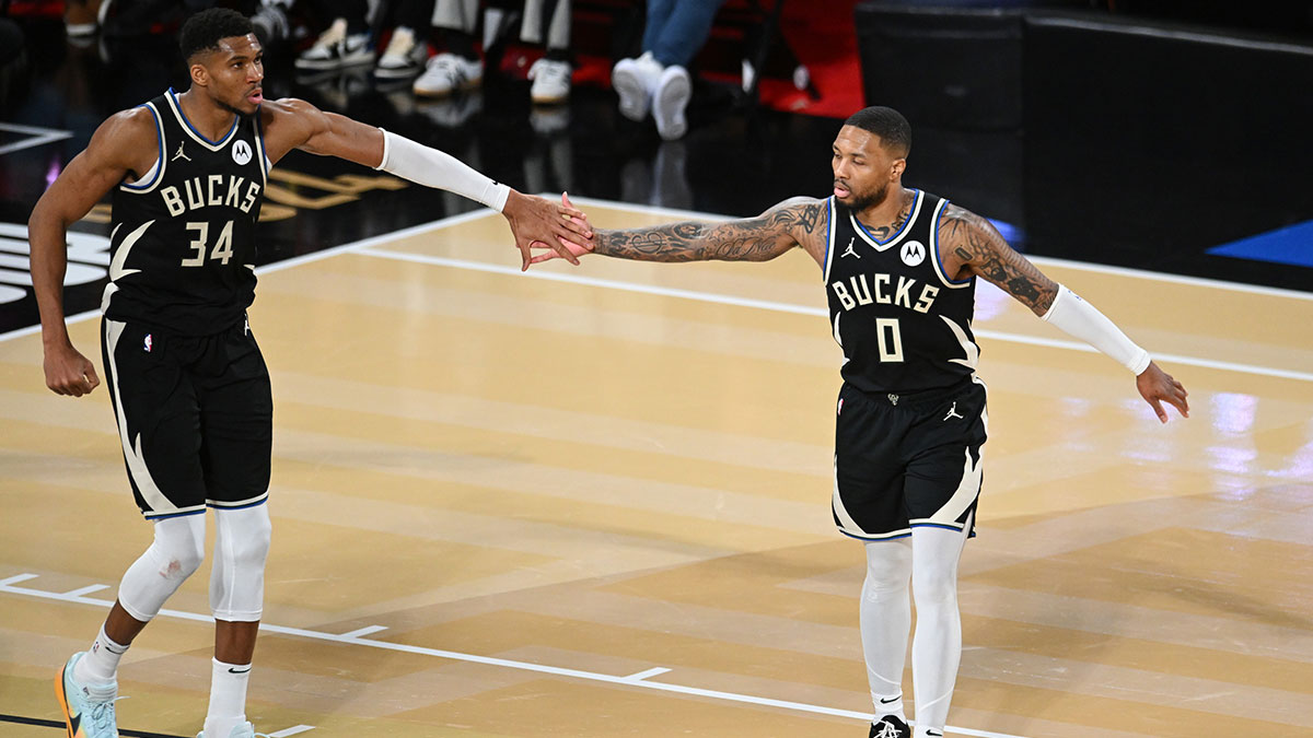 Milwaukee Bucks guard Damian Lillard (0) and forward Giannis Antetokounmpo (34) react during the fourth quarter against the Atlanta Hawks in a semifinal of the 2024 Emirates NBA Cup at T-Mobile Arena.