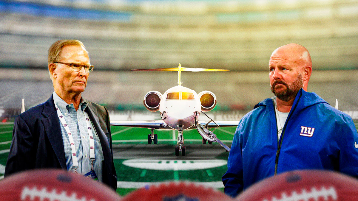Giants Brian Daboll and Giants John Mara with a light aircraft between them