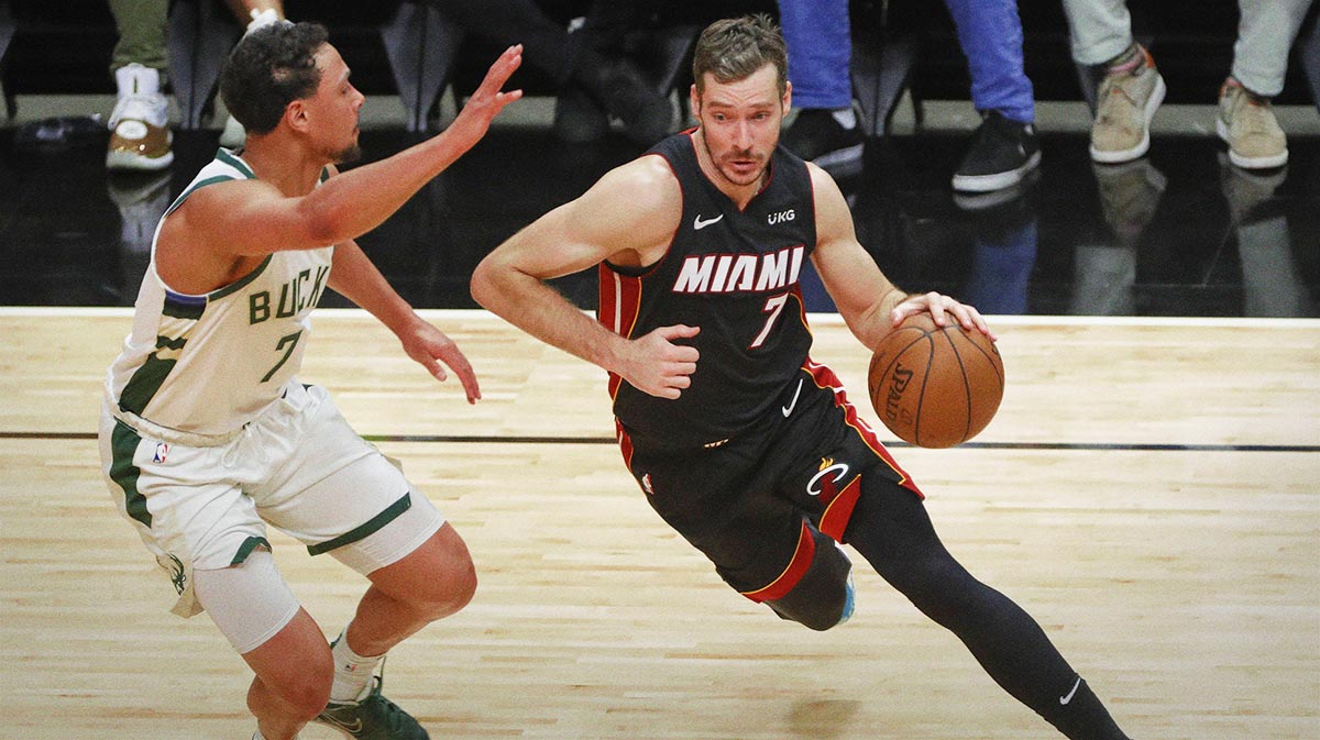 Miami Heat guard Goran Dragic (right) dribbles the basketball against Milwaukee Bucks guard Bryn Forbes (left) during the second quarter of game four in the first round of the 2021 NBA Playoffs at American Airlines Arena.