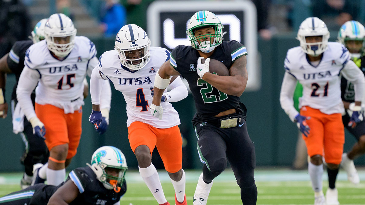 Tulane Green Wave running back Makhi Hughes (21) runs against UTSA Roadrunners running back Kevorian Barnes (4) during the first half at Yulman Stadium.