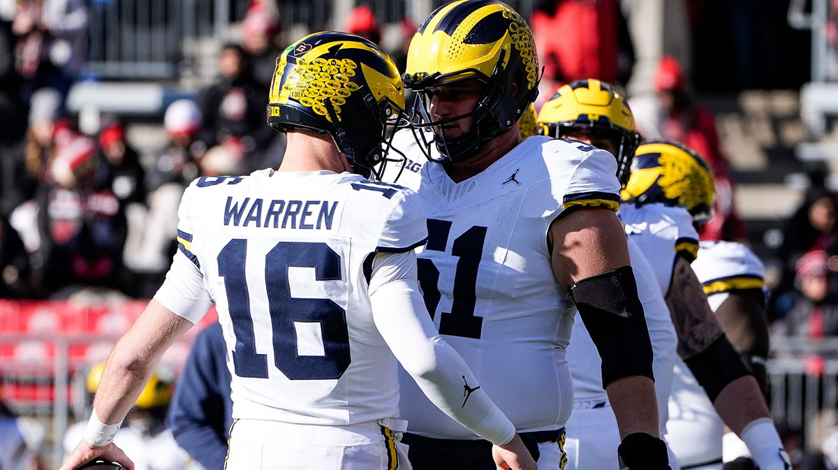 Michigan quarterback Davis Warren (16) talks to offensive lineman Greg Crippen (51) at warm up before the game between Ohio State and Michigan at Ohio Stadium