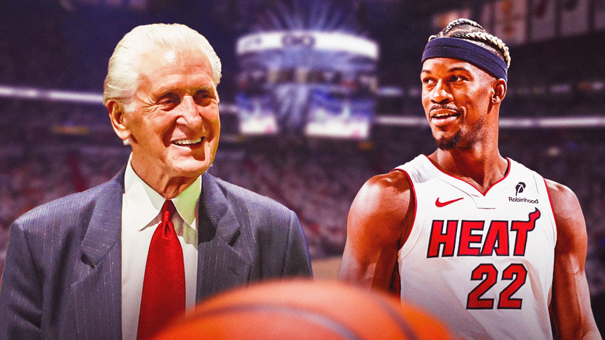 Jimmy Butler and Pat Riley smiling at each other.