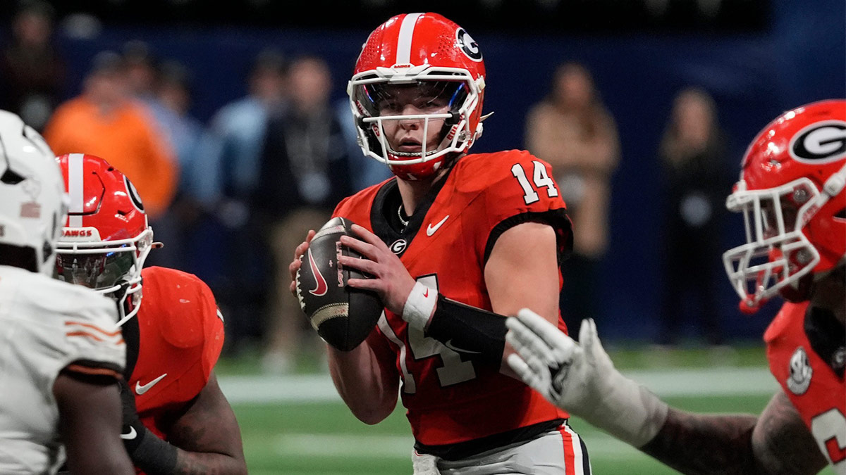 Georgia quarterback Gunner Stockton (14) looks to throw a pass during overtime of the SEC championship game against Texas in Atlanta, on Saturday, Dec. 7, 2024.