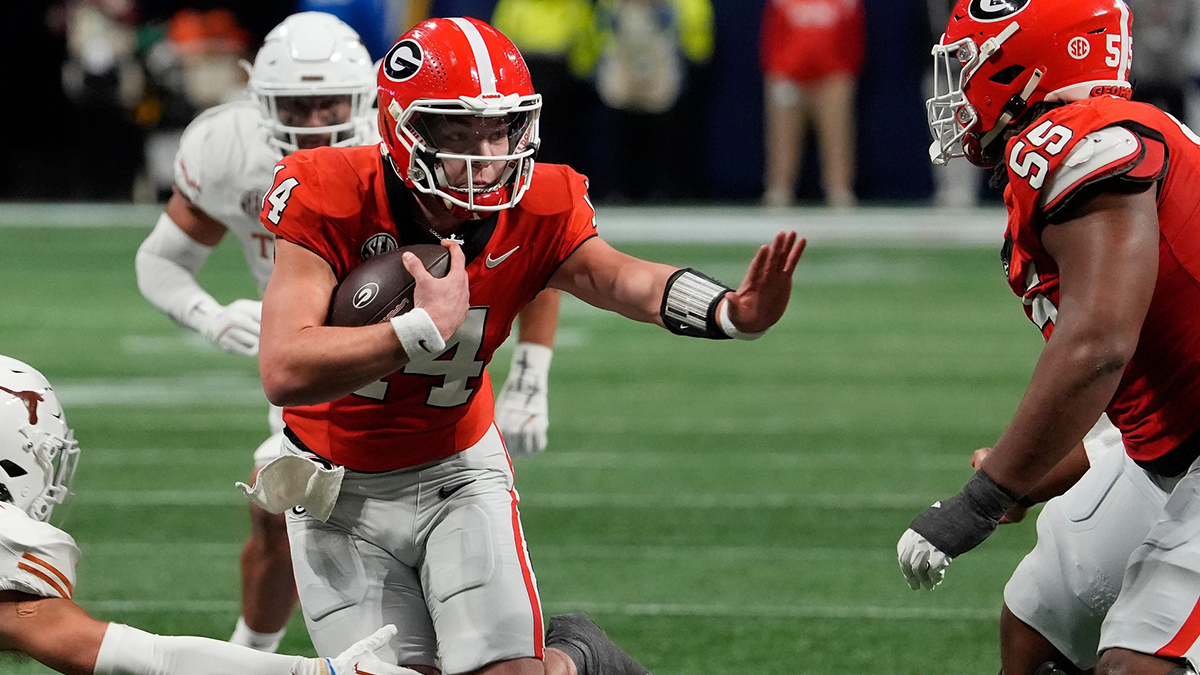Georgia quarterback Gunner Stockton (14) runs the ball during the second half of the SEC championship game against Texas in Atlanta, on Saturday, Dec. 7, 2024.