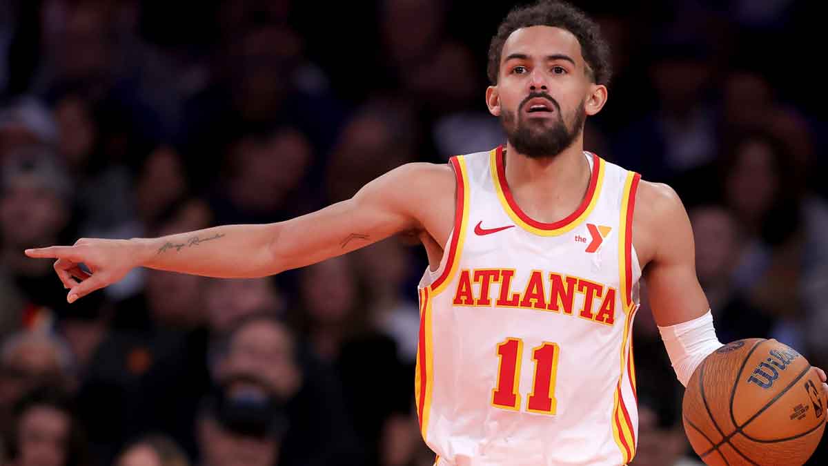 Hawks guard Trae Young (11) brings the ball up