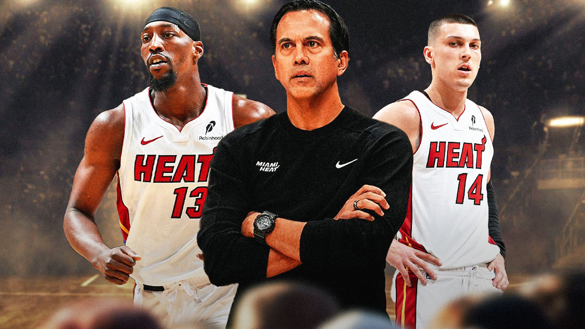Miami Heat head coach Erik Spoelstra in the middle with Bam Adebayo and Tyler Herro on either side in front of Kaseya Center.