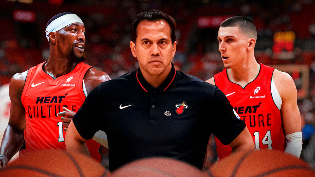 Miami Heat head coach Erik Spoelstra in the middle with Tyler Herro and Bam Adebayo on either side in front of Kaseya Center.