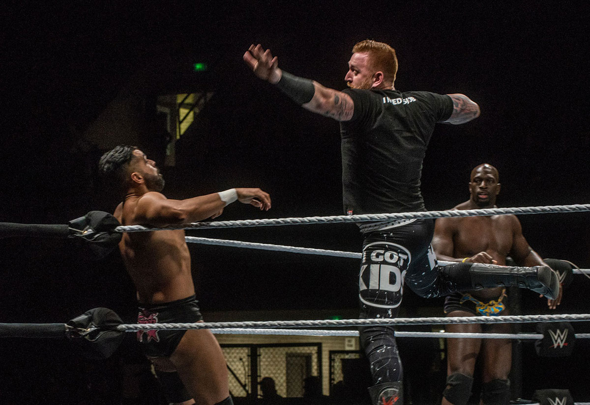 Heath Slater wrestling the Singh Brothers at a WWE live event.