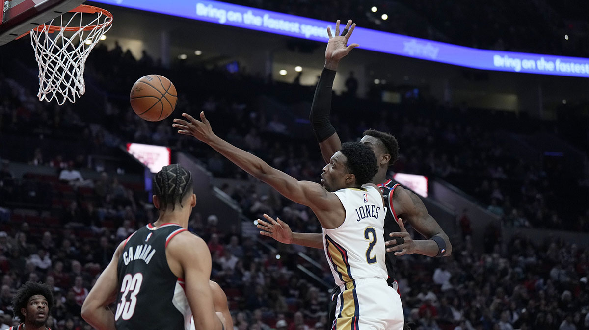 New Orleans Pelicans small forward Herbert Jones (2) shoots the ball around Portland Trail Blazers center Deandre Ayton (2, right) during the first half at Moda Center.