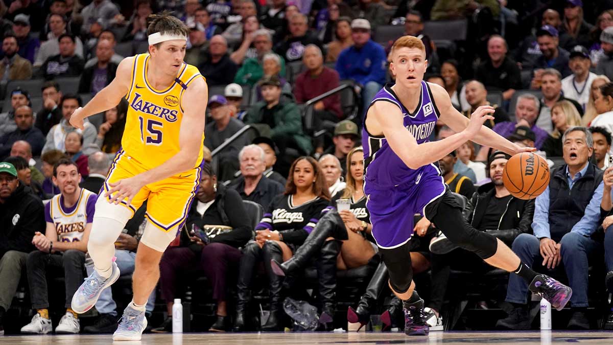 Sacramento Kings guard Kevin Huerter (9) dribbles past Los Angeles Lakers guard Austin Reaves (15) in the third quarter at the Golden 1 Center.