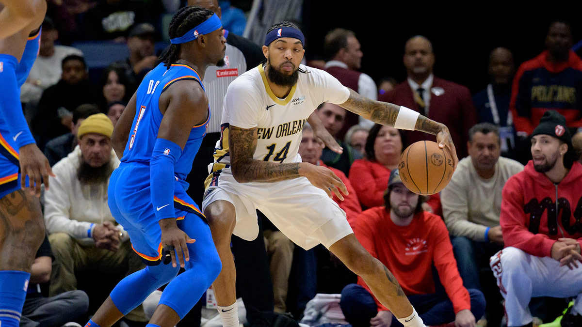 New Orleans Pelicans forward Brandon Ingram (14) dribbles against Oklahoma City Thunder guard Luguentz Dort (5) during the first half at Smoothie King Center.