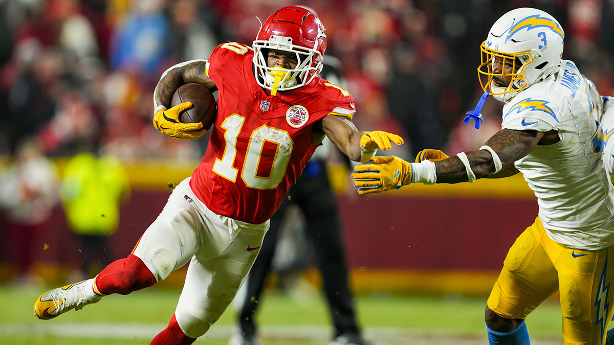 Kansas City Chiefs running back Isiah Pacheco (10) runs with the ball against Los Angeles Chargers safety Derwin James Jr. (3) during the second half at GEHA Field at Arrowhead Stadium.