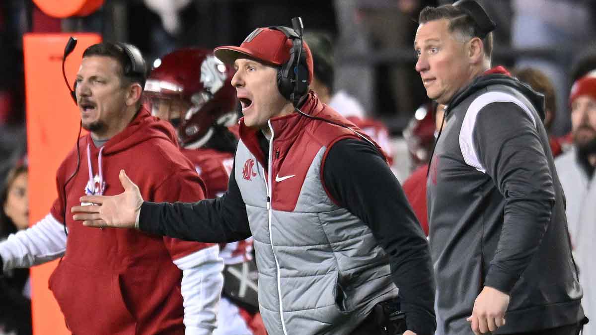 Washington State Cougars head coach Jake Dickert, center, reacts after a play against the Wyoming Cowboys in the second half at Gesa Field at Martin Stadium. Washington State Cougars won 15-14.