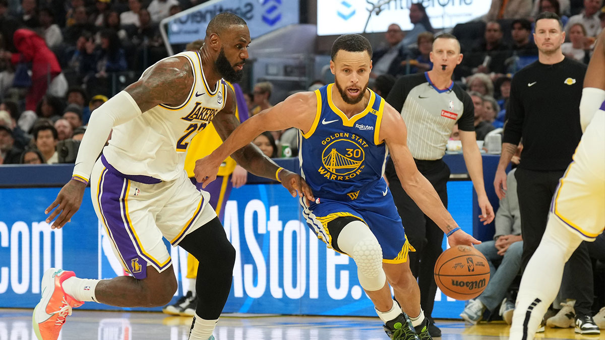 Golden State Warriors guard Stephen Curry (30) dribbles against Los Angeles Lakers forward LeBron James (left) during the third quarter at Chase Center.