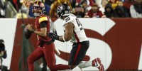 Dec 29, 2024; Landover, Maryland, USA; Washington Commanders quarterback Jayden Daniels (5) scrambles from Atlanta Falcons defensive tackle David Onyemata (90) during the second quarter at Northwest Stadium. Mandatory Credit: Geoff Burke-Imagn Images