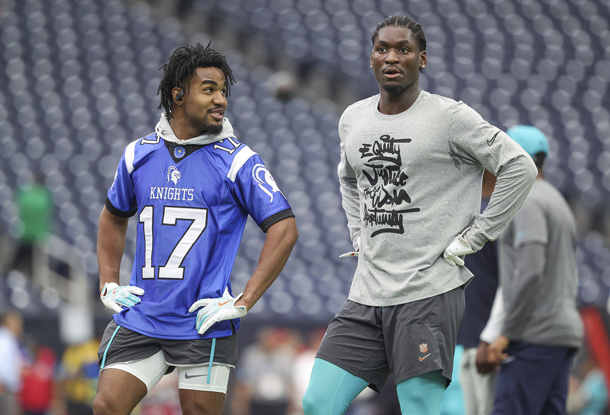 Miami Dolphins wide receiver Jaylen Waddle (left) and wide receiver Grant DuBose (right) talk on the field before the game against the Houston Texans at NRG Stadium. 