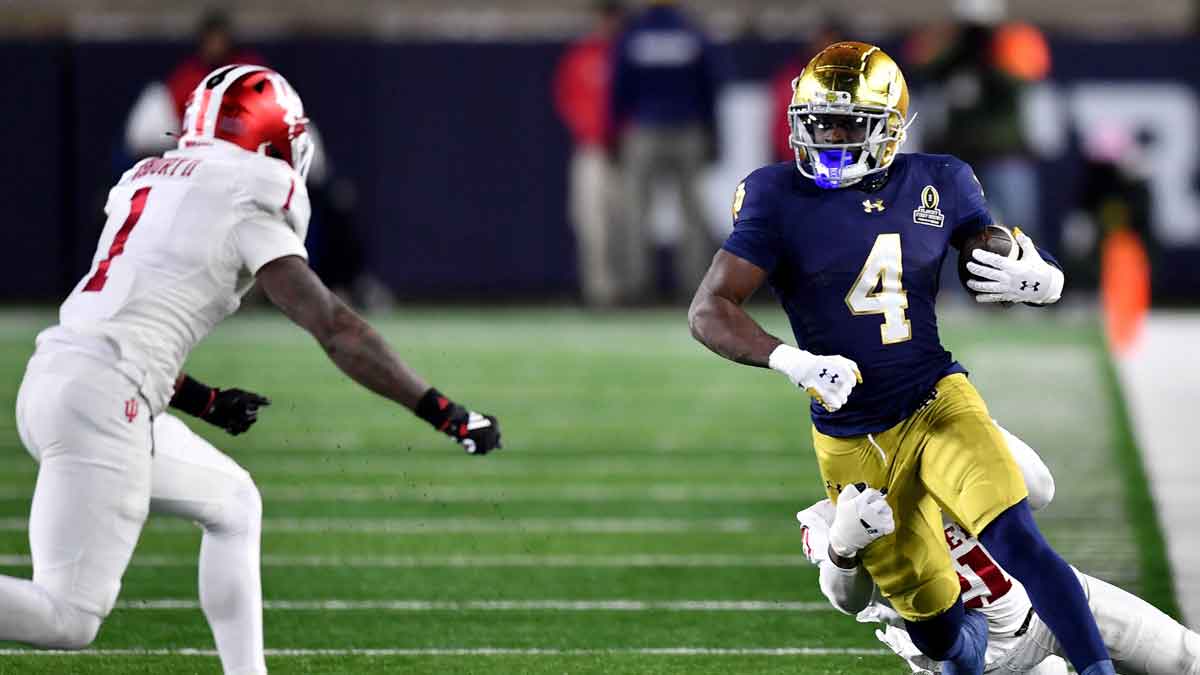 Notre Dame, Indiana, USA; Notre Dame Fighting Irish running back Jeremiyah Love (4) runs against Indiana Hoosiers linebacker Rolijah Hardy (21) and defensive back Shawn Asbury II (1) during the third quarter at Notre Dame Stadium