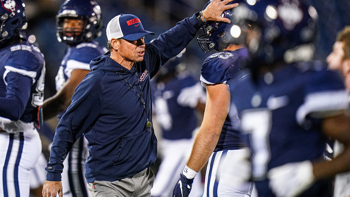 Connecticut Huskies head coach Jim Mora on the field during warm up before the start of the game against the Georgia State Panthers at Rentschler Field at Pratt & Whitney Stadium