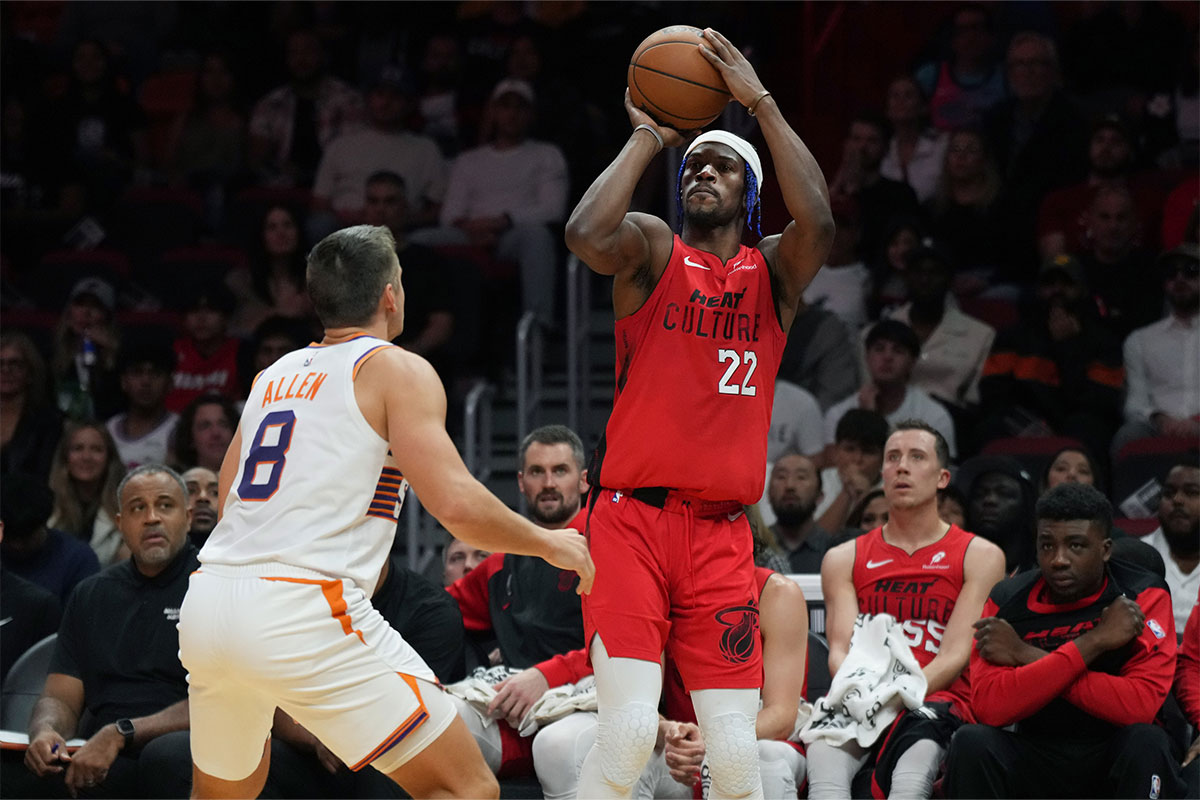 Miami Heat forward Jimmy Butler (22) shoots the ball against Phoenix Suns guard Grayson Allen (8) during the second half at Kaseya Center.