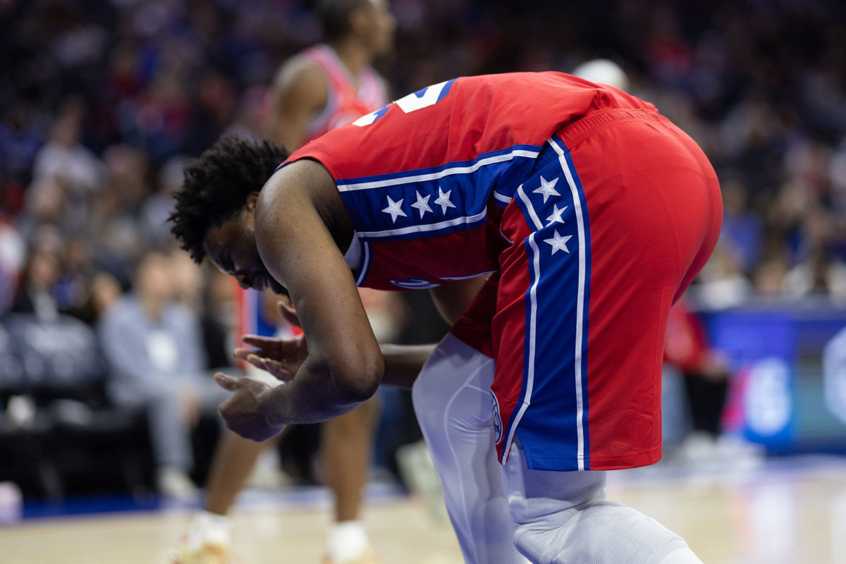 Philadelphia 76ers center Joel Embiid (21) grabs his face after a collision during the second quarter at Wells Fargo Center.