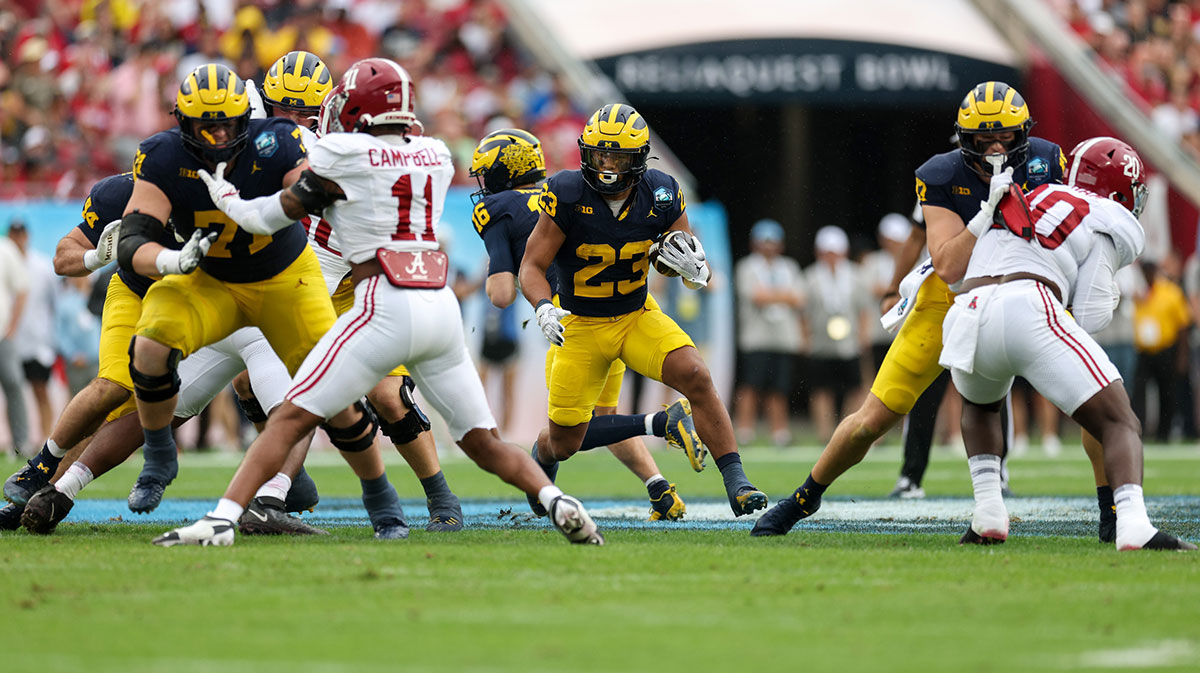 Michigan Wolverines running back Jordan Marshall (23) runs with the ball against the Alabama Crimson Tide in the first quarter during the ReliaQuest Bowl at Raymond James Stadium.