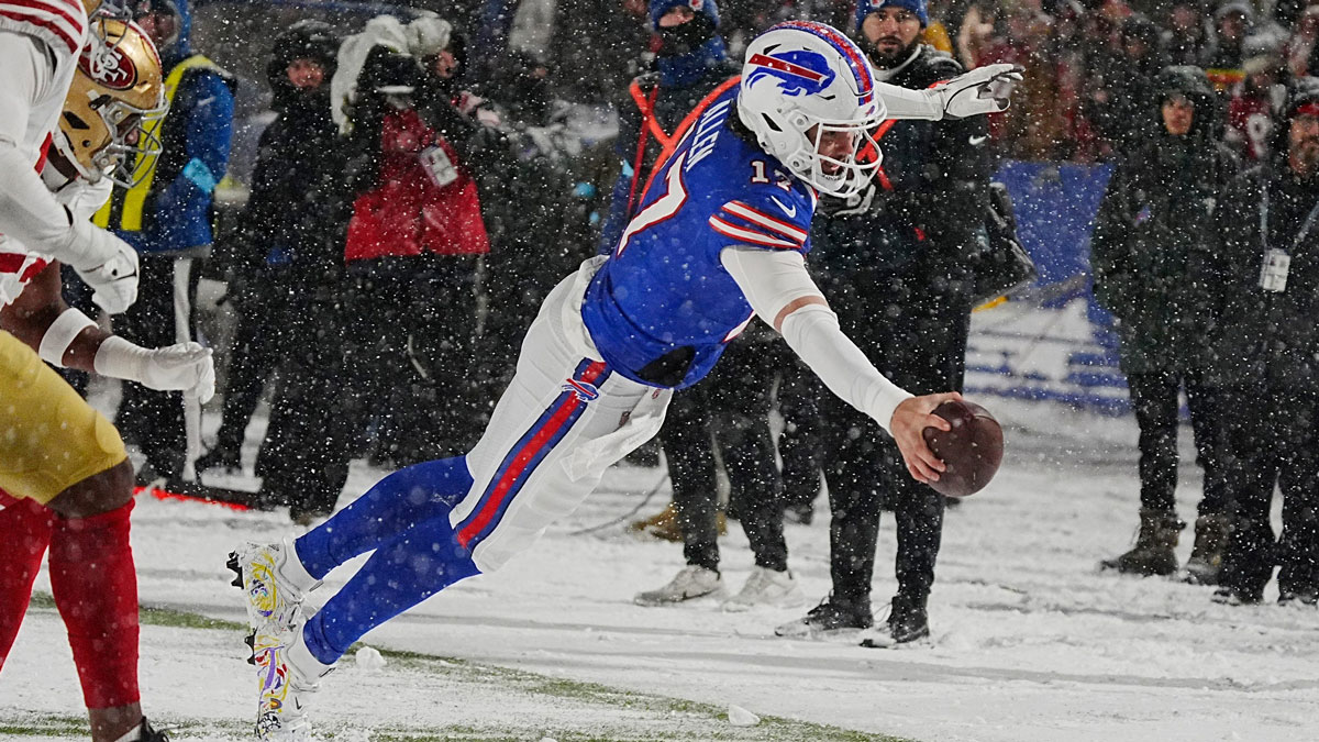 Bills Josh Allen leaps to the end zone in a nine-yard touchdown run after getting the ball passed back to him from Amari Cooper during second half action of their home game against the San Francisco 49ers in Orchard Park on Dec. 1, 2024.