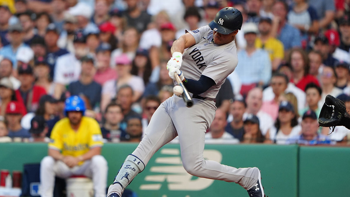 New York Yankees left fielder Juan Soto (22) hits a two-run home run against the Boston Red Sox during the first inning at Fenway Park. 