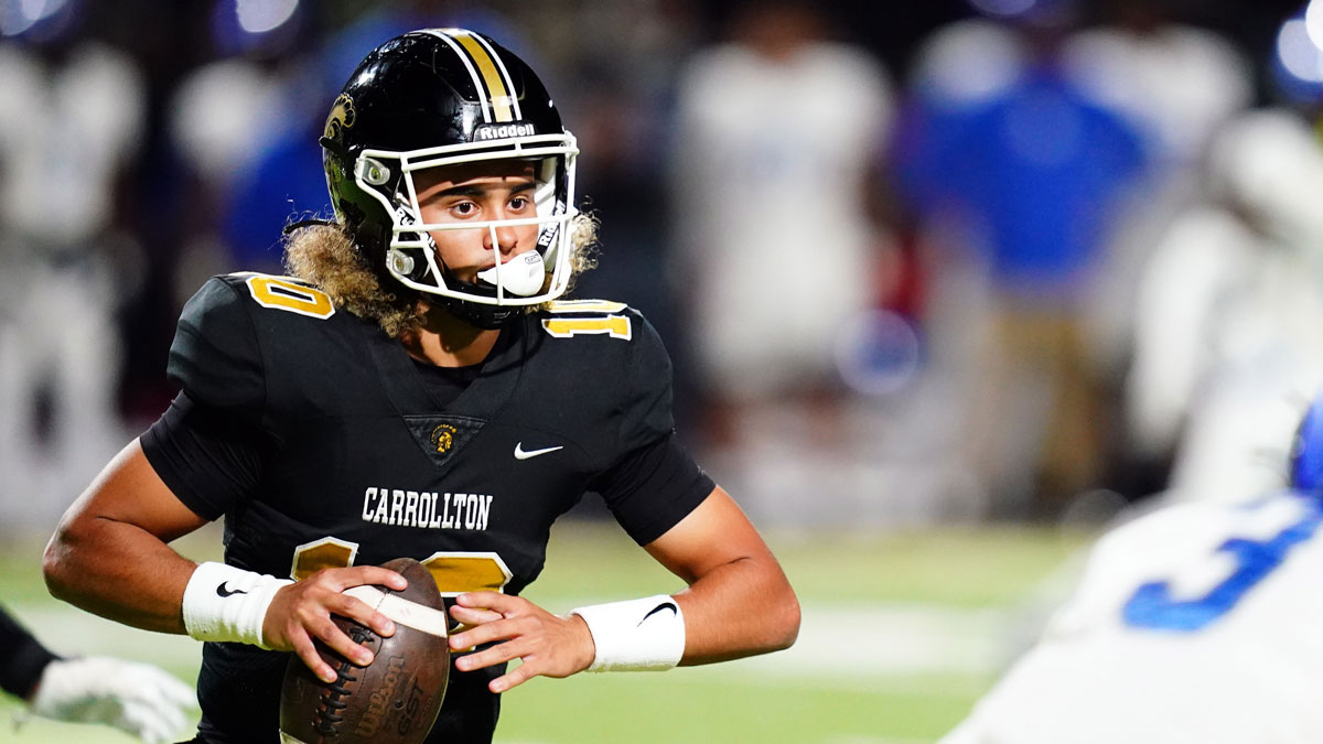 Carrollton Trojans quarterback Julian Lewis (10) scrambles out of the pocket against the Westlake Lions during the first half at Grisham Stadium. The 15-year-old Carrollton High student has already committed to playing for the University of Southern California Trojans and has been considered one of the top high school quarterback prospects.
