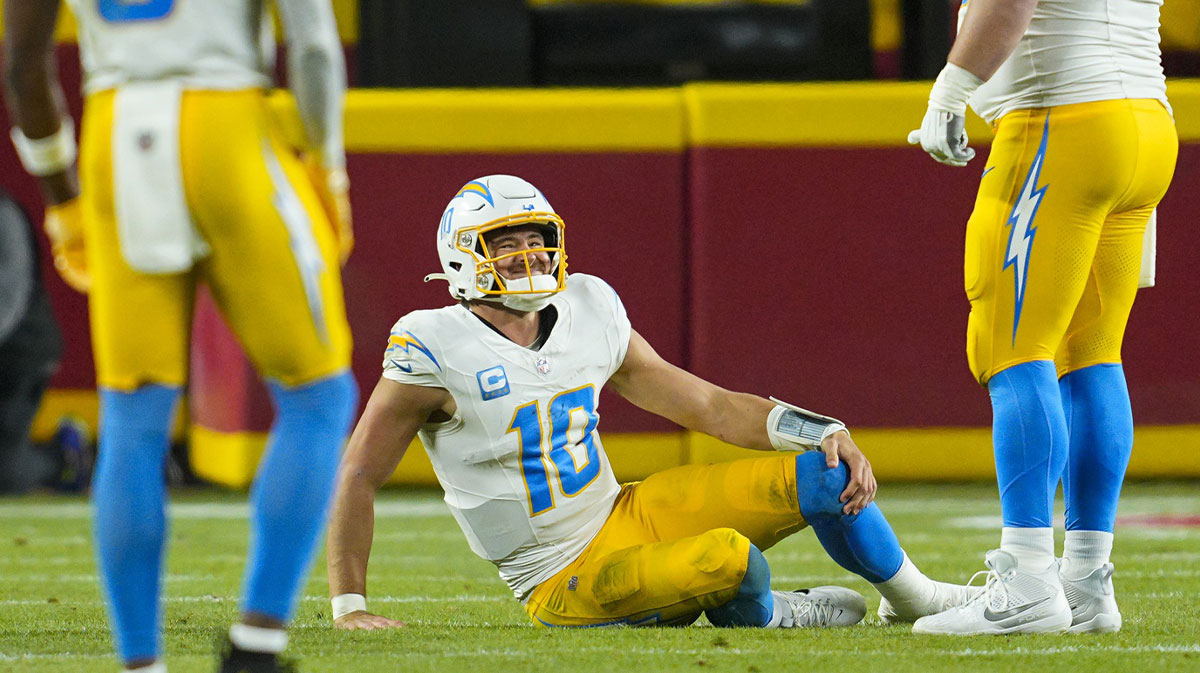 Los Angeles Chargers quarterback Justin Herbert (10) reacts after an injury during the first half against the Kansas City Chiefs at GEHA Field at Arrowhead Stadium.