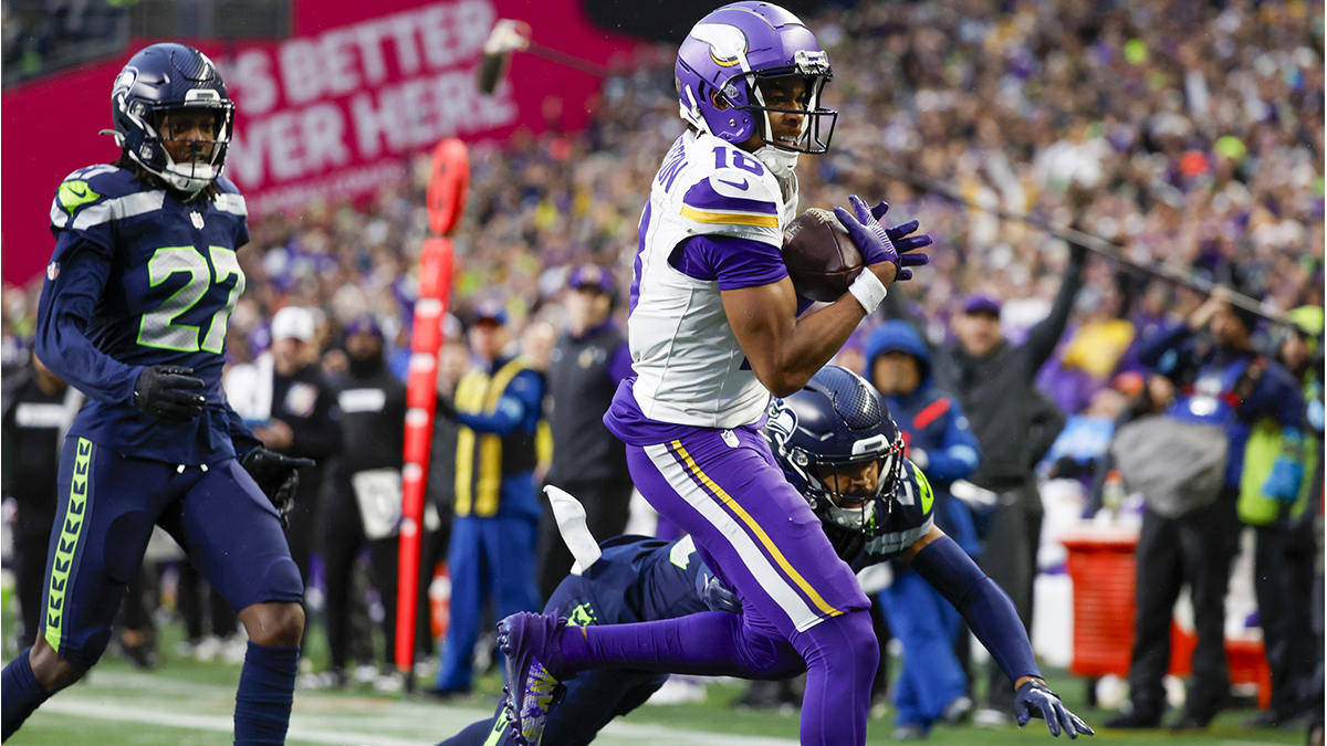 Minnesota Vikings wide receiver Justin Jefferson (18) catches a touchdown pass against Seattle Seahawks safety Julian Love (20) during the fourth quarter at Lumen Field.
