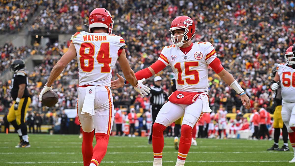 Kansas City Chiefs wide receiver Justin Watson (84) celebrates an 11-yard touchdown with quarterback Patrick Mahomes (15) against the Pittsburgh Steelers during the first quarter at Acrisure Stadium.