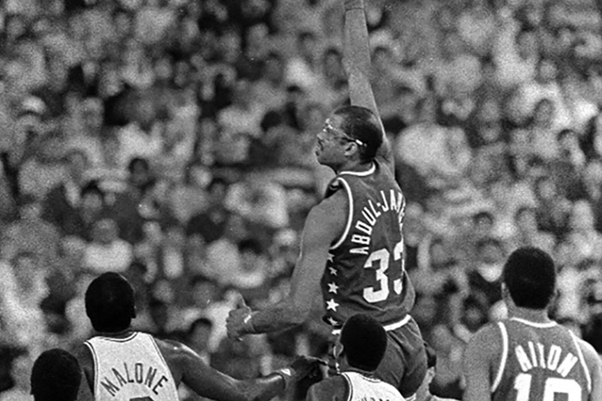 Kareem Abdul-Jabbar sky hooks over Julius Irving, Moses Malone, Isaiah Thomas as Norm Nixon looks on during the NBA All Star game at the Hoosier Dome