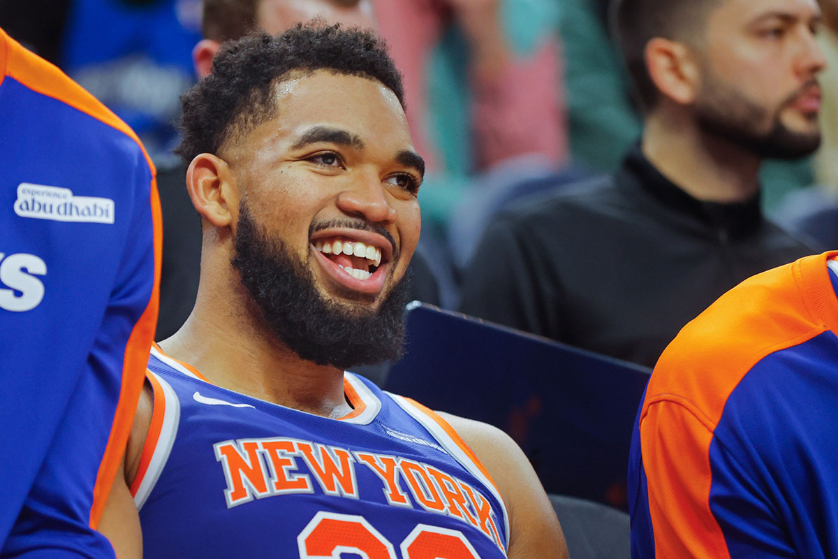 New York Knicks forward Karl-Anthony Towns (32) smiles as he rests on the bench in the fourth quarter of the game with the Minnesota Timberwolves at Target Center.