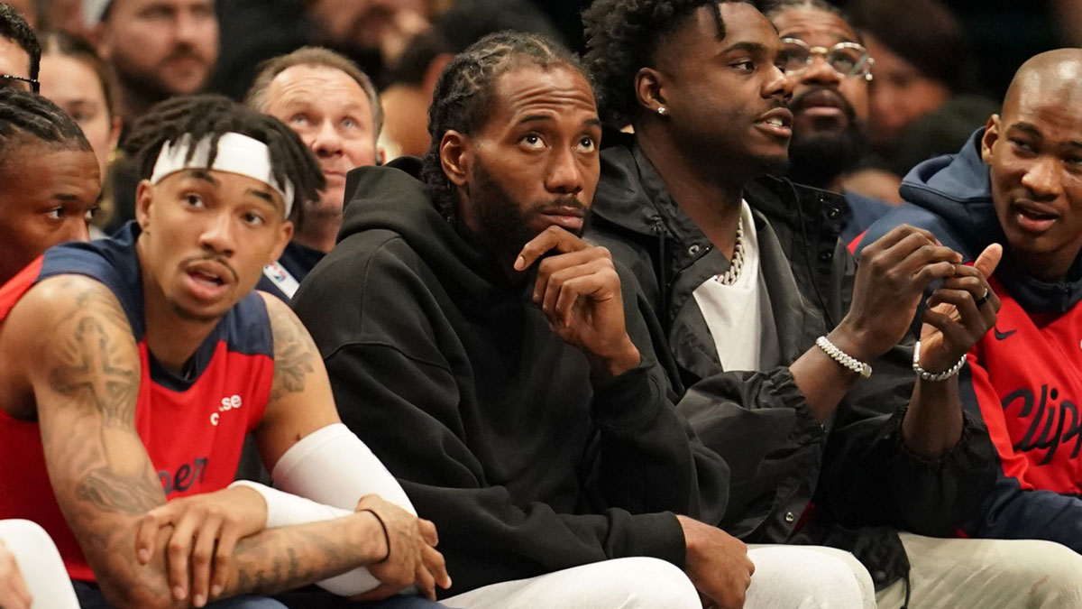 Kawhi Leonard looks on from the bench in street clothes during the game against the Dallas Mavericks during the second half at American Airlines Center.
