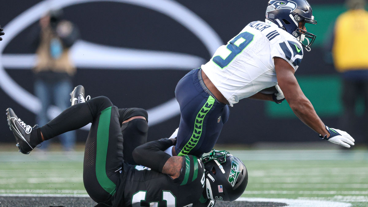 Seattle Seahawks running back Kenneth Walker III (9) is tackled by New York Jets safety Chuck Clark (36) during the second half at MetLife Stadium.