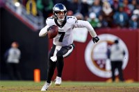 Philadelphia Eagles quarterback Kenny Pickett (7) runs the ball during the fourth quarter against the Washington Commanders at Northwest Stadium.