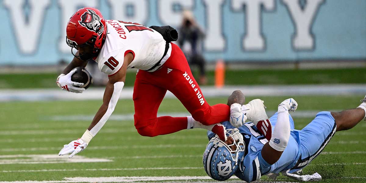 North Carolina State Wolfpack wide receiver Kevin Concepcion (10) with the ball as North Carolina Tar Heels linebacker Amare Campbell (17) defends in the first quarter at Kenan Memorial Stadium.