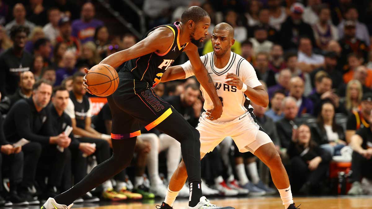 Phoenix Suns forward Kevin Durant (35) against San Antonio Spurs guard Chris Paul (3) in the first half of an NBA Cup game at Footprint Center.