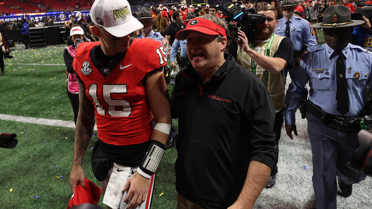 Dec 7, 2024; Atlanta, GA, USA; Georgia Bulldogs quarterback Carson Beck (15) and head coach Kirby Smart react after defeating the Texas Longhorns in overtime in the 2024 SEC Championship game at Mercedes-Benz Stadium.