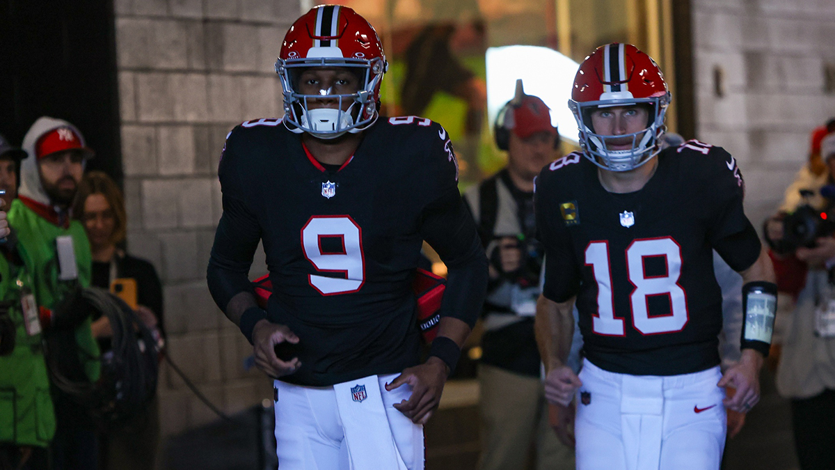 Atlanta Falcons quarterback Michael Penix Jr. (9) and quarterback Kirk Cousins (18) run on the field before a game against the New York Giants at Mercedes-Benz Stadium.