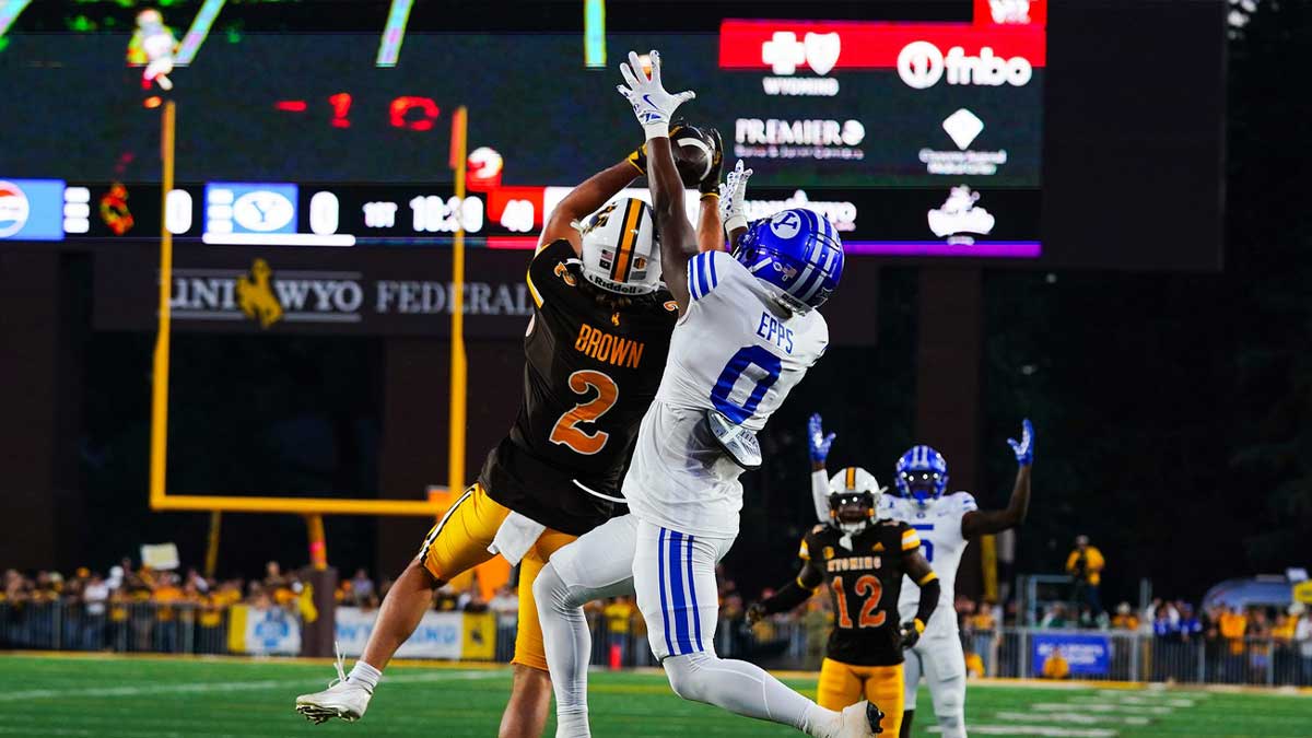 Wyoming Cowboys nose guard Wrook Brown (2) makes an interception against Brigham Young Cougars wide receiver Kody Epps (0) during the first quarter at Jonah Field at War Memorial Stadium.