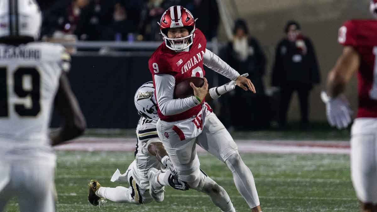 Indiana Hoosiers quarterback Kurtis Rourke (9) runs the ball while Purdue Boilermakers defensive back Kyndrich Breedlove (10) defends in the second half at Memorial Stadium.