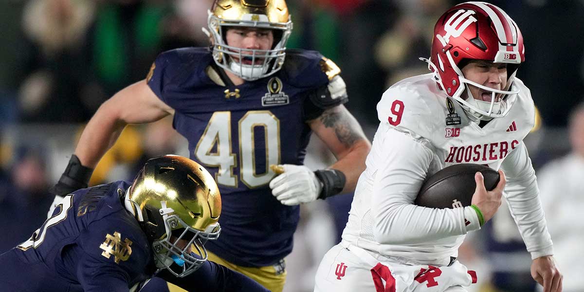 Indiana Hoosiers quarterback Kurtis Rourke (9) runs the ball while Notre Dame Fighting Irish defensive lineman Loghan Thomas (10) attempts to tackle him during the second half of a game between the Indiana Hoosiers and the Notre Dame Fighting Irish in first round of the College Football Playoff on Saturday, Dec. 21, 2024, in South Bend. Notre Dame defeated Indiana 27-17.