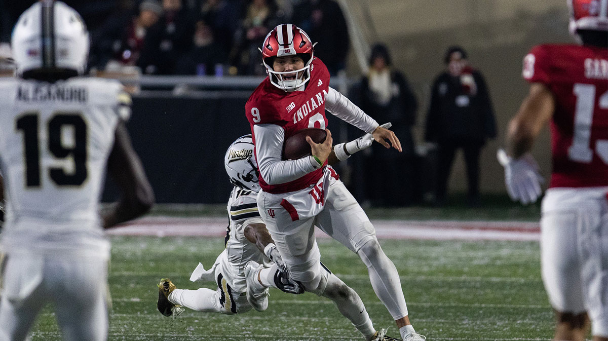 Indiana Hoosiers quarterback Kurtis Rourke (9) runs the ball while Purdue Boilermakers defensive back Kyndrich Breedlove (10) defends in the second half at Memorial Stadium.