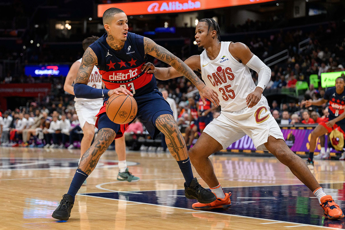 Washington Wizards forward Kyle Kuzma (33) dribbles the ball against Cleveland Cavaliers forward Isaac Okoro (35) during the second quarter at Capital One Arena.