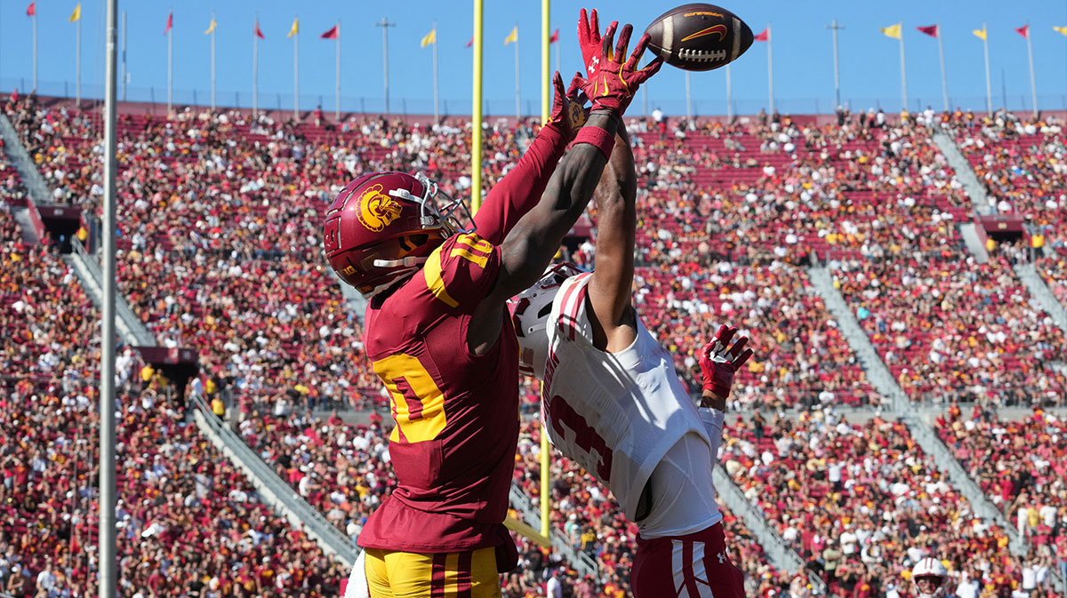 Southern California Trojans wide receiver Kyron Hudson (10) attempts to catch the ball against Wisconsin Badgers cornerback Nyzier Fourqurean (3) in the second half at United Airlines Field at Los Angeles Memorial Coliseum.