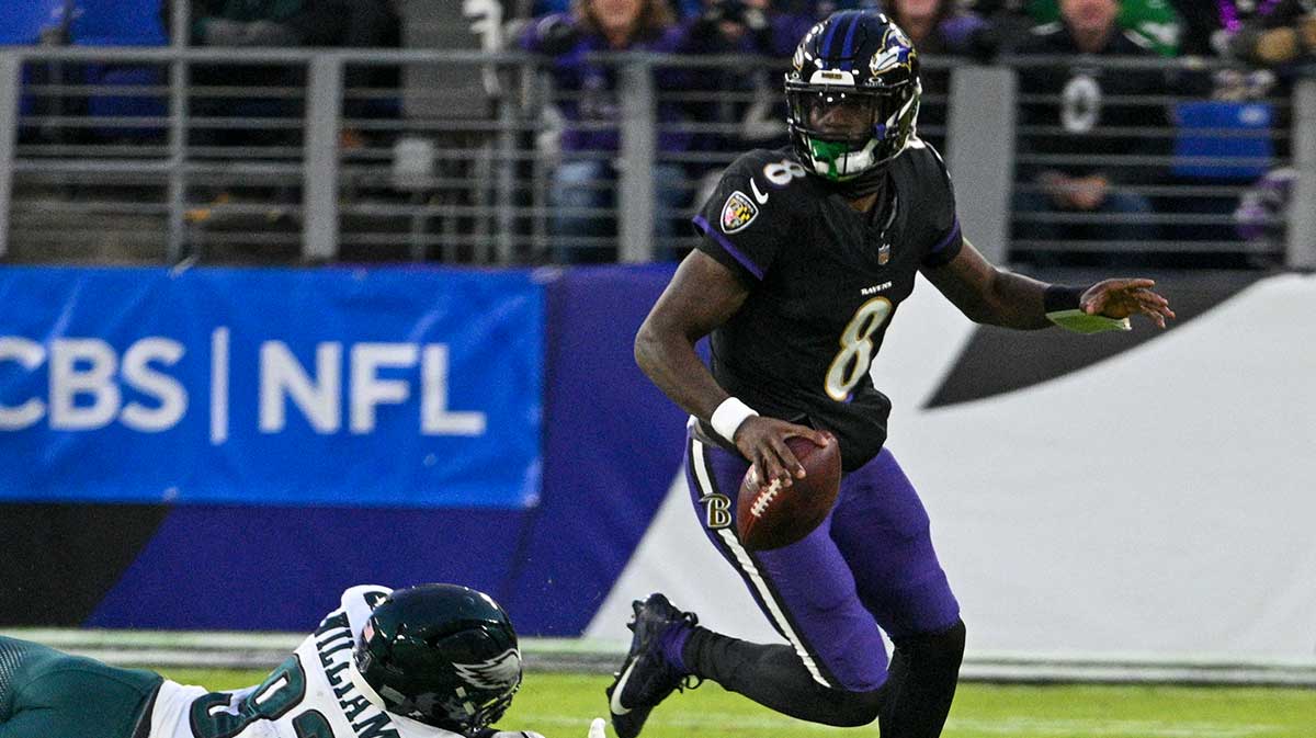 Baltimore Ravens quarterback Lamar Jackson (8) scrambles away from Philadelphia Eagles defensive tackle Milton Williams (93) during the first quarter at M&T Bank Stadium.