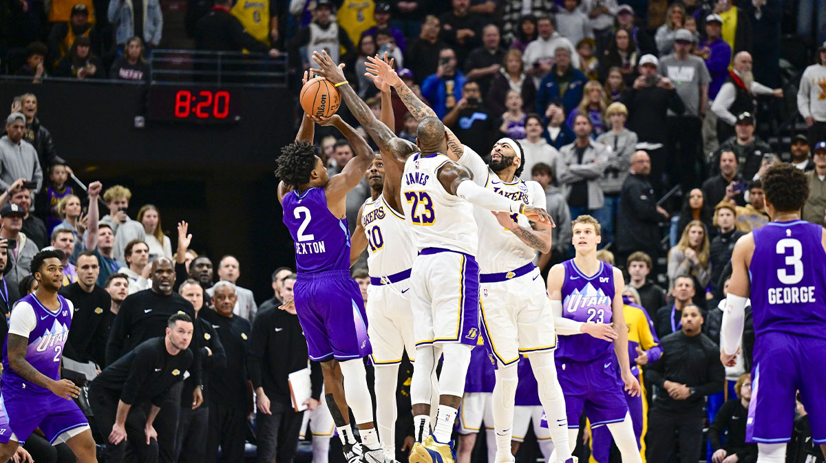 Utah Jazz guard Collin Sexton (2) gets blocked by Los Angeles Lakers forward LeBron James (23), forward/center Anthony Davis (3), and center Christian Koloko (10) in the final second of the second half at the Delta Center.