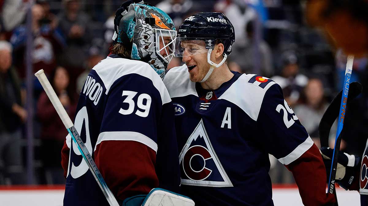 Colorado Avalanche goaltender Mackenzie Blackwood (39) and center Nathan MacKinnon (29) celebrate after the game against the Nashville Predators at Ball Arena.