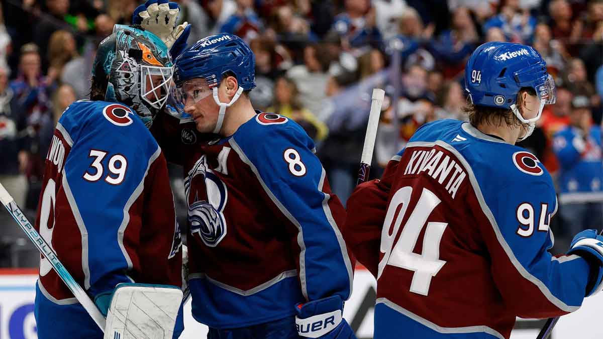 Colorado Avalanche goaltender Mackenzie Blackwood (39) celebrates with defenseman Cale Makar (8) and left wing Joel Kiviranta (94) after the game against the Seattle Kraken at Ball Arena.